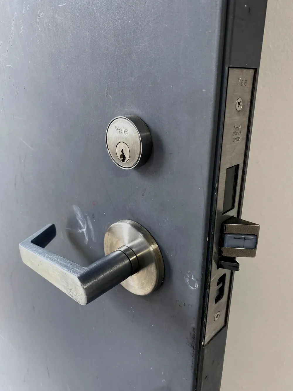 Commercial mortise lever lock and deadbolt on a steel business door
