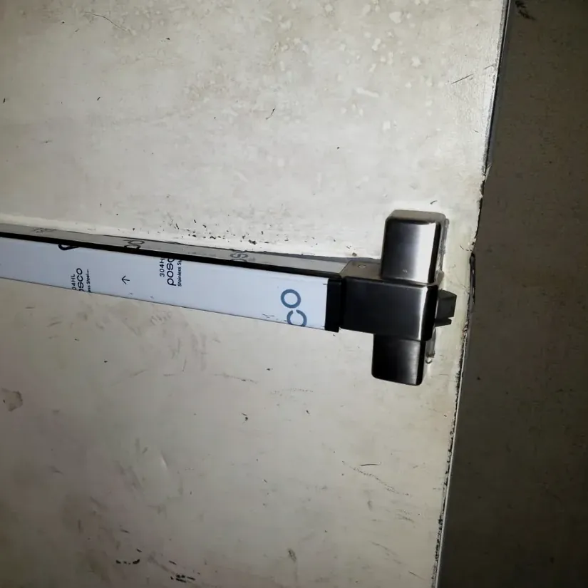 Panic bar exit device on a steel door