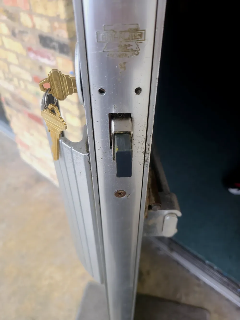 Keys in the lock of an aluminum storefront door