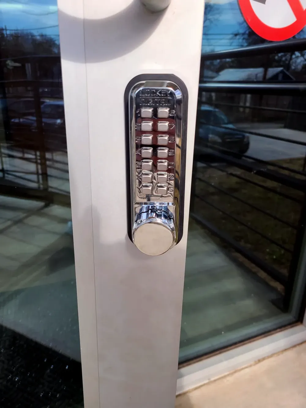 Mechanical keypad lock on an aluminum storefront door
