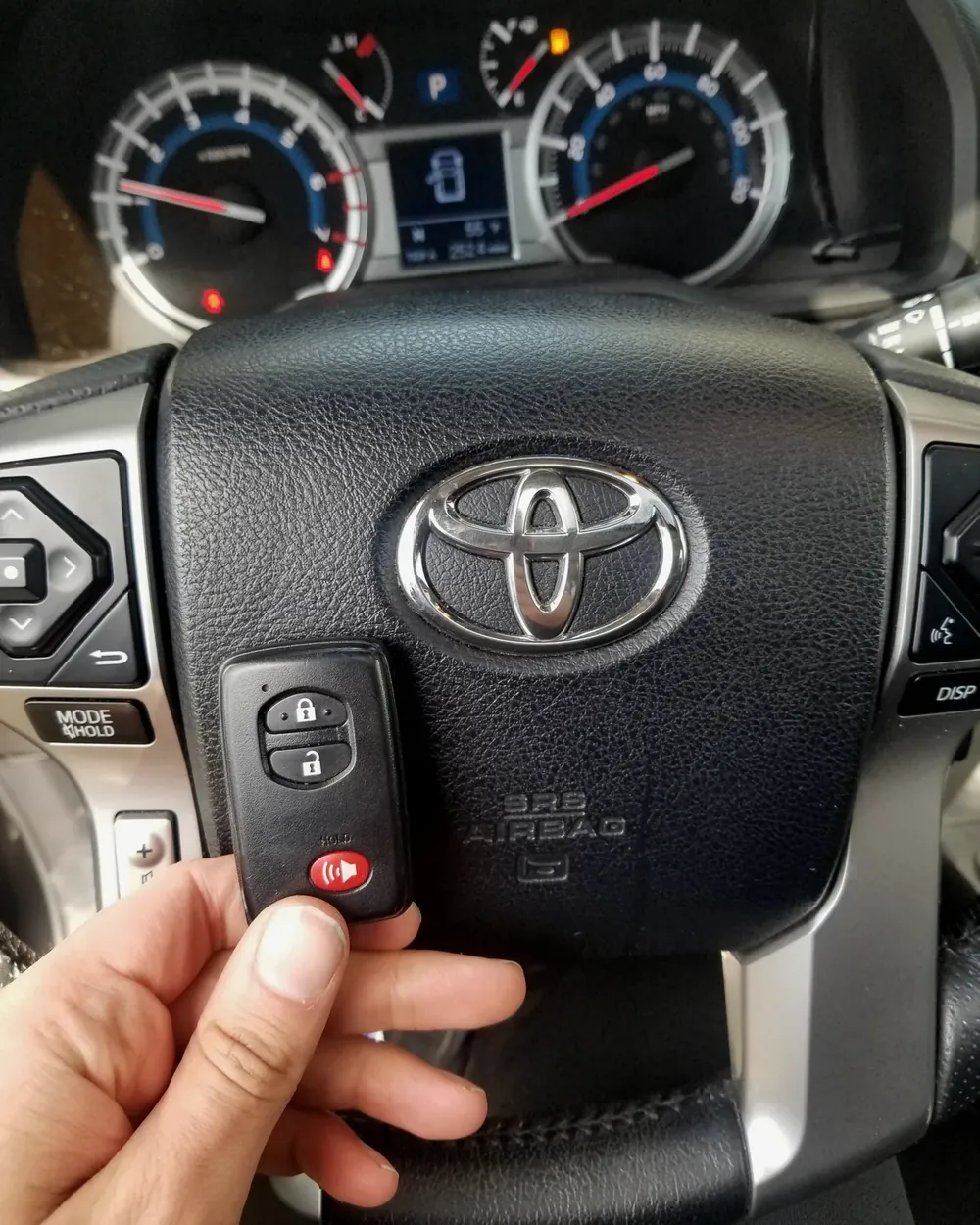 New push-to-start smart key held at the steering wheel