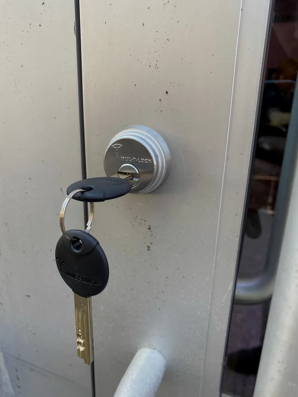 Key in a deadbolt above a lever handle on an apartment door